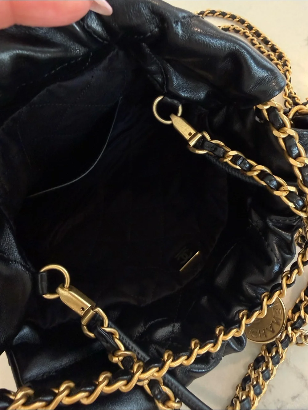 CHANEL 22 Mini Black Quilted Leather Drawstring Crossbody with Gold Logo Charm